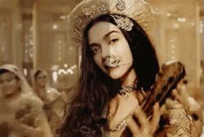 a woman is wearing a hat and holding a guitar .