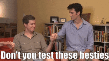 two men sitting on a couch holding hands with the words " do n't you test these besties " on the bottom