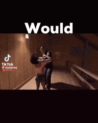 a man and a woman are standing next to each other in a dark room with the words `` would '' on the bottom .