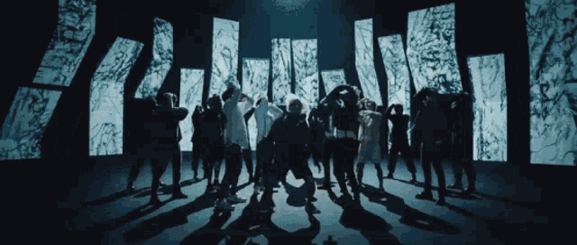 a group of people are dancing in front of a screen that shows a city