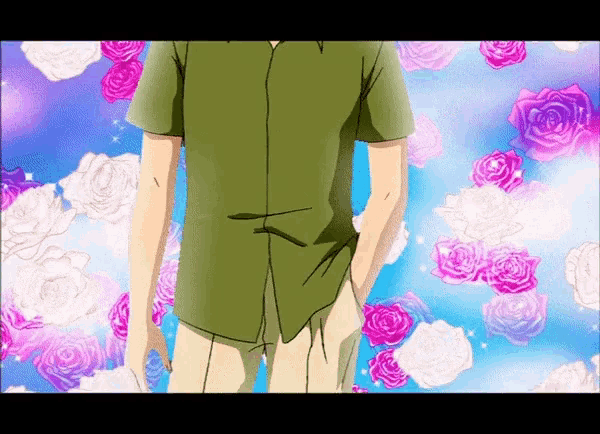 a man in a green shirt stands in front of roses