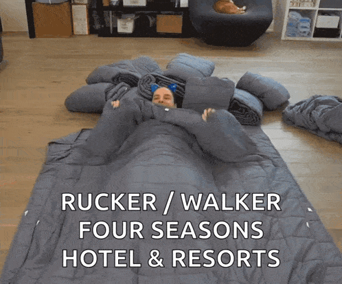 a man laying in a pile of blankets with the words rucker / walker four seasons hotel & resorts