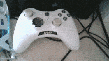 a white msi game controller sits on a table