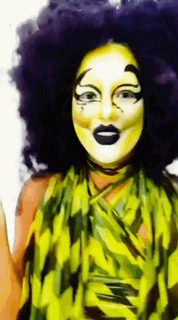 a woman with a purple afro is wearing a green and yellow outfit