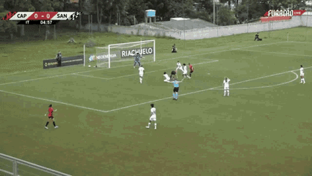 a soccer game is being played on a field and the score is 0-0