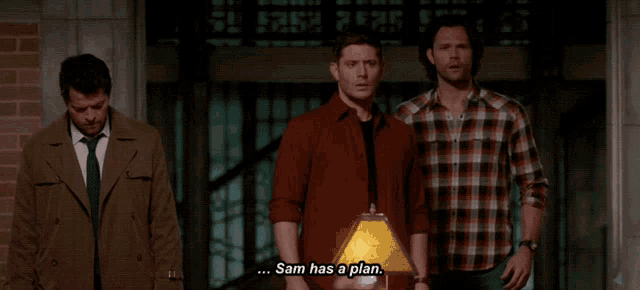 three men are standing in front of a sign that says sam has a plan