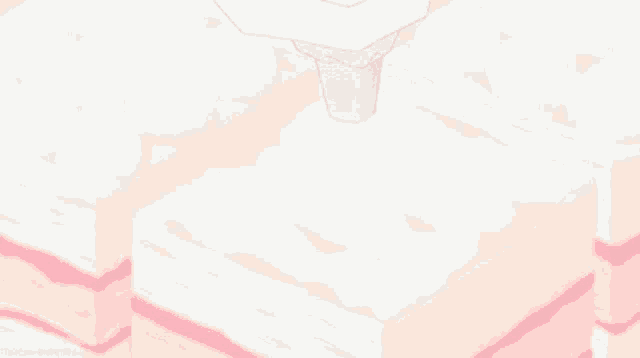 a person is piping whipped cream on a pink cake .