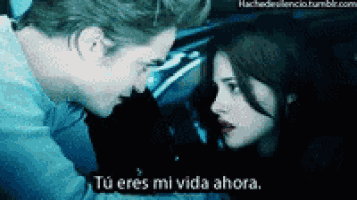 a man and a woman are looking at each other with the words " tu eres mi vida ahora " written below them