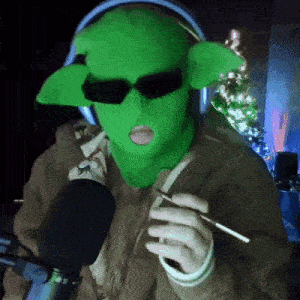 a person wearing a green mask and sunglasses is smoking a cigarette .