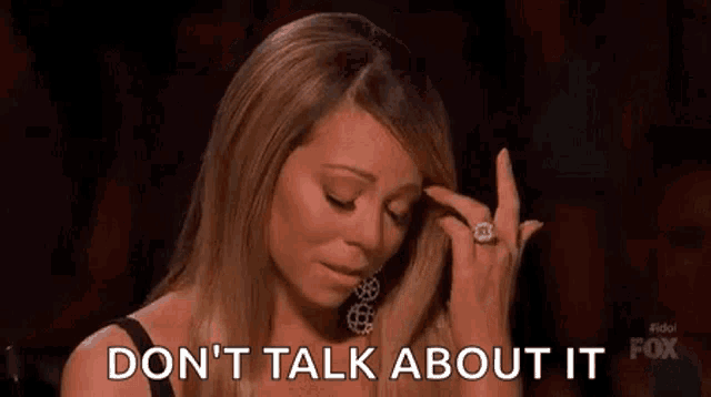 a woman is crying while holding her finger to her forehead and saying `` do n't talk about it '' .