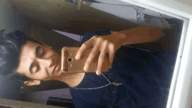 a young man takes a selfie with his phone