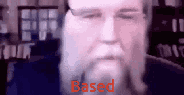 a close up of a man 's face with the word based written in red
