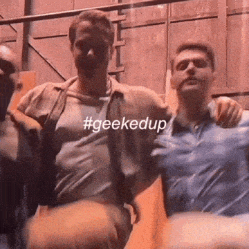 two men standing next to each other with the hashtag #geekedup on the bottom right