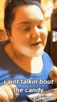 a woman in a blue shirt says i ain 't talkin bout the candy
