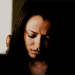 a close up of a woman 's face with a dark background