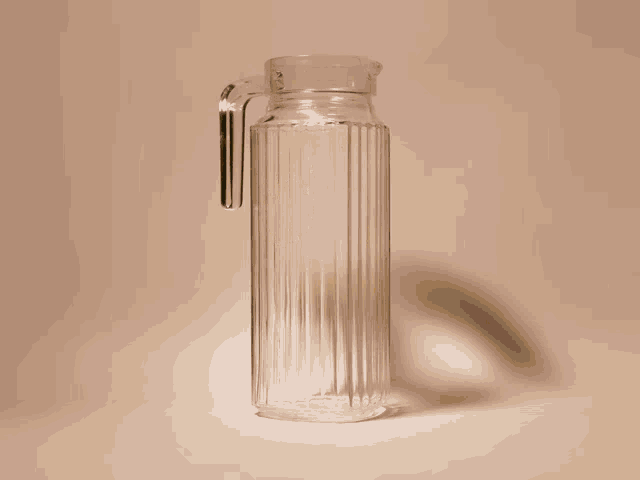 a pitcher of iced tea with lemon slices and straws