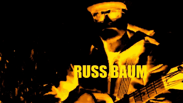 a man with the name russ baum written in yellow