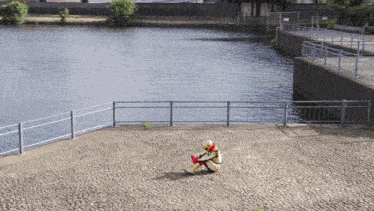 a person in a superhero costume sits on the ground near a river