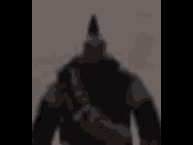 a blurry picture of a man with a gun in his hand .