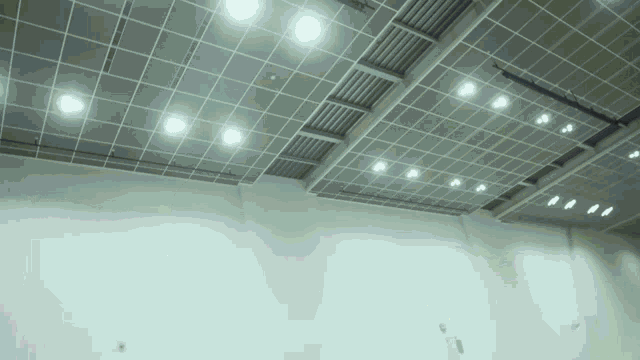a ceiling with a lot of lights on it and a white wall