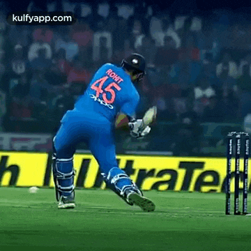 a cricket player in a blue jersey with the number 45 on the back is playing a game of cricket .