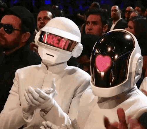 a couple of people wearing white helmets with a heart on them .