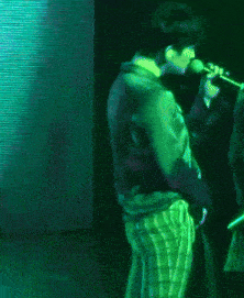 a green pixelated image of a man and woman dancing