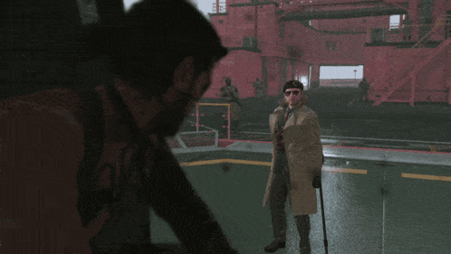 a man in a trench coat stands next to another man in sunglasses