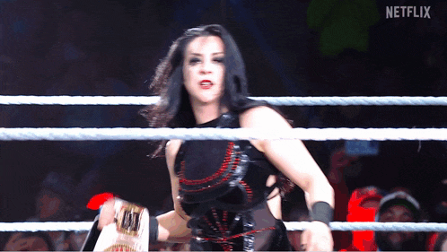 a woman in a wrestling ring with a netflix logo on the bottom