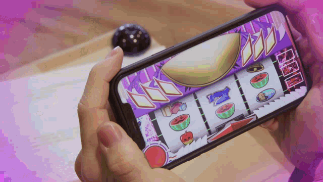 a person is playing a slot machine on their phone