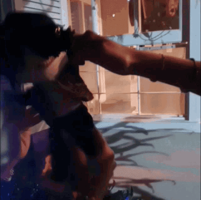a person is holding another person 's arm in a dark room