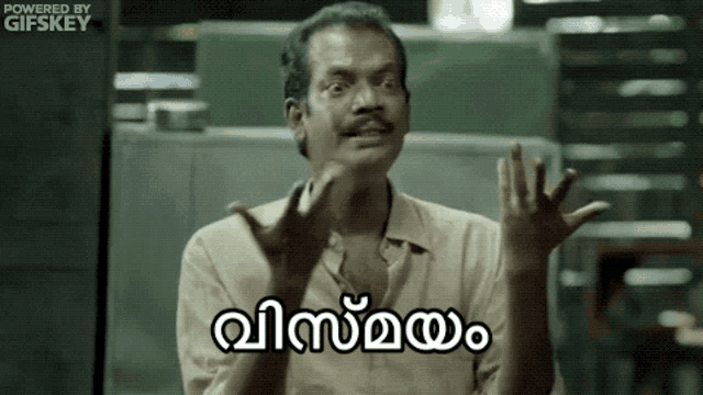 a man with a mustache is making a funny face with his hands outstretched and a caption in a foreign language .