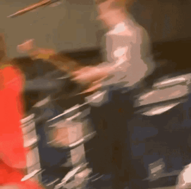 a blurry picture of a man playing a drum set