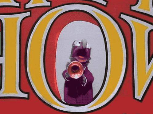 a purple monster is holding a trumpet in front of a sign that says hot