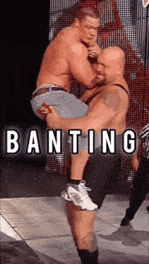 a wrestler is carrying another wrestler in his arms with the word banting written above them