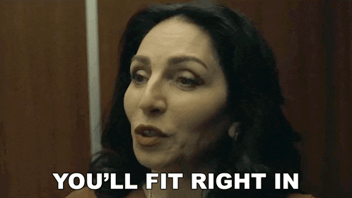 a woman is making a funny face and saying you 'll fit right in .