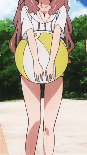 a girl holding a yellow and white beach ball in her hands