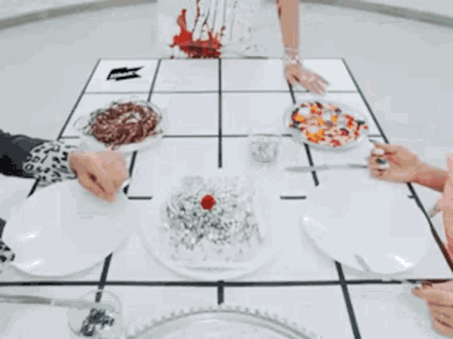 a woman wearing a bloody apron is holding a plate of food