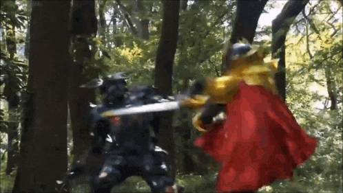a man in a red cape is fighting another man in a forest with a sword .