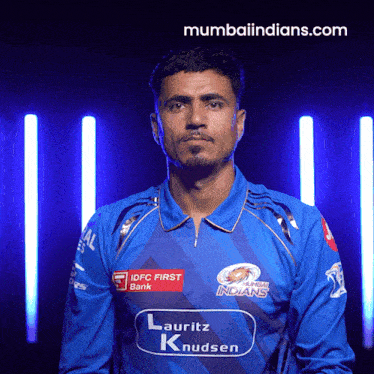 a man wearing a blue shirt that says indians on it