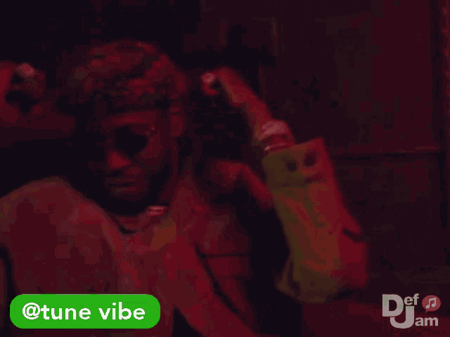 a man wearing sunglasses and a hat is dancing with a tune vibe sticker next to him
