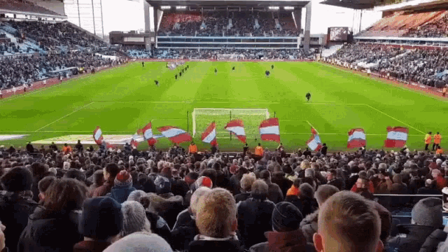 a crowd of people are watching a soccer game in a stadium .