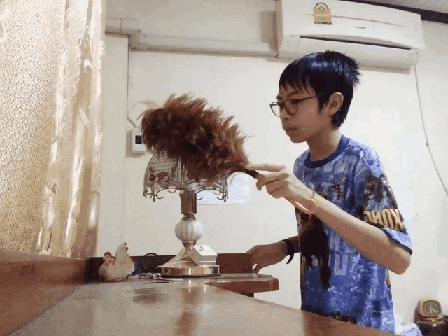 a boy wearing a blue shirt that says okmc on it