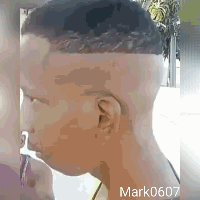 a man with a braided haircut has the name mark written on the bottom right