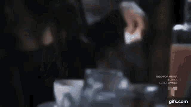 a close up of a woman 's face with a blurry background of people .