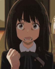 a close up of a girl 's face with a surprised expression