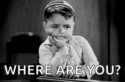 a black and white photo of a little boy sitting at a desk with his hand on his chin and the words `` where are you ? ''