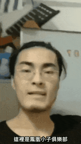 a man wearing glasses looks at the camera with chinese writing on the bottom