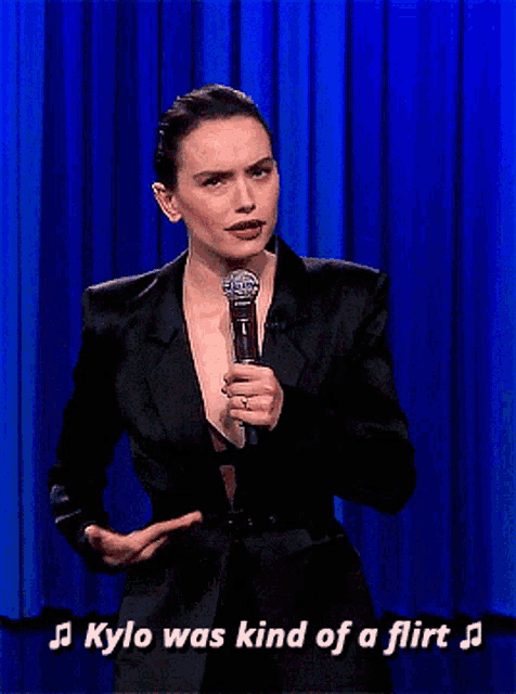 a woman singing into a microphone with the words kylo was kind of a flirt behind her