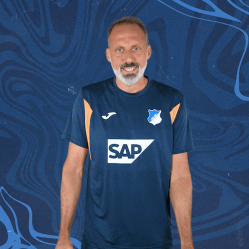 a man wearing a blue shirt that says sap on it